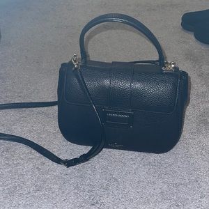 Black Kate Spade shoulder bag with top handle.